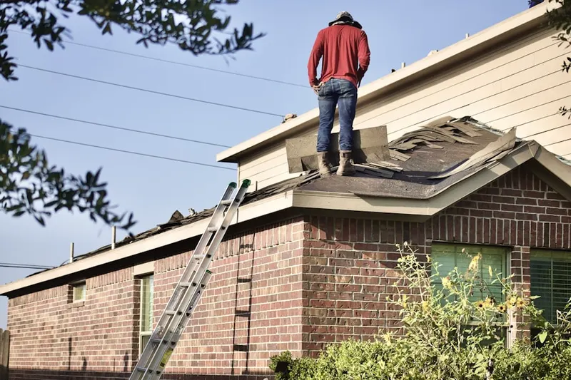 Professional roofer working on a residential roof in Carefree Crossing